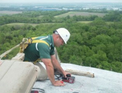 A man performing concrete scanning services at the top of a water tower in Cincinnati Dayton Road in Monroe, Ohio.