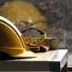yellow hard hat and yellow goggles on the table by the window